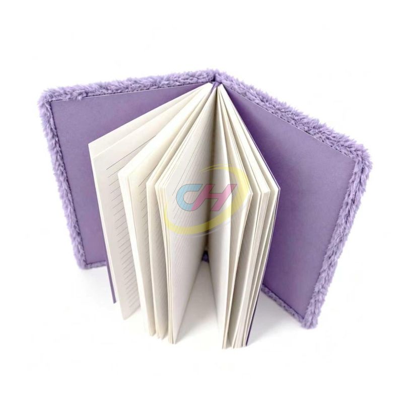 Open purple plush notebook with ruled pages and matching endpapers