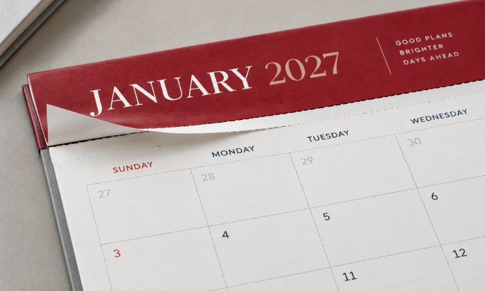 Fixed top header and perforated tear line on a desk pad calendar