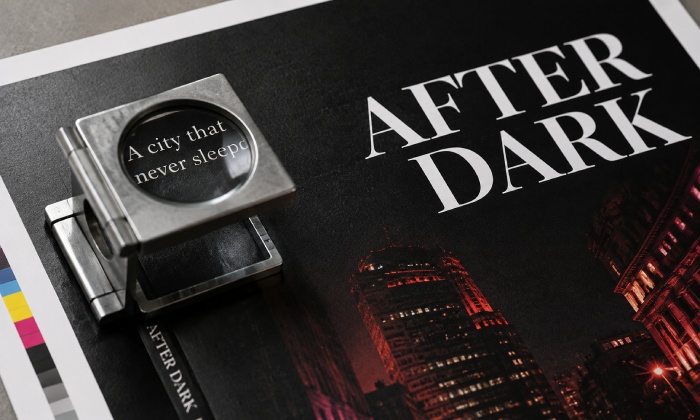 Small and large reverse white type printed on a rich black background